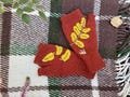 Hand knitted fingerless mittens in a rich rust color with hand embroidered yellow leaves and mushrooms