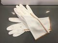 white silky casual fall gloves-tight white gloves w a orange & green criss cross  embroidery sewn pattern accent on the side n at the wrist